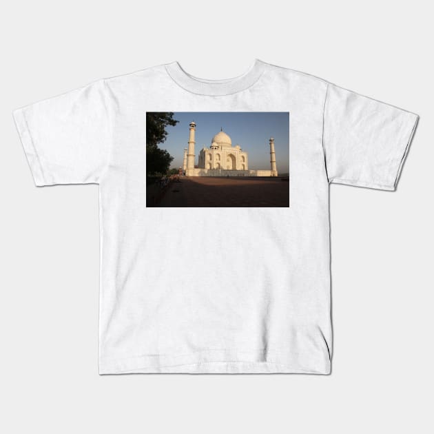 The Taj Mahal as the sun rises. Kids T-Shirt by JohnDalkin